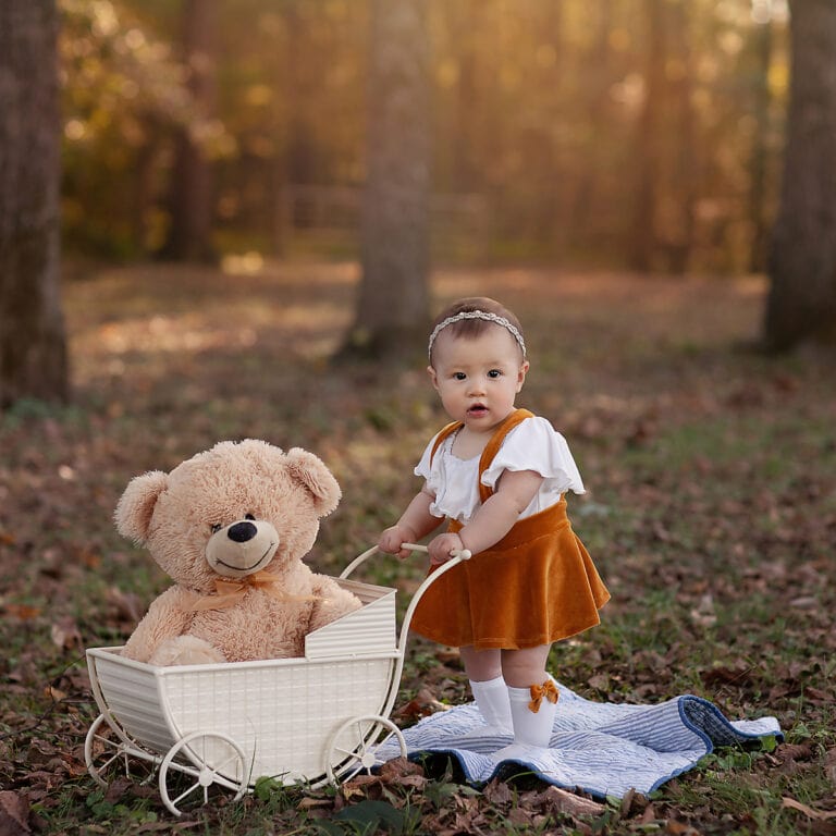 Milestone session at park baby pushing carriage - Belle Haven Photography